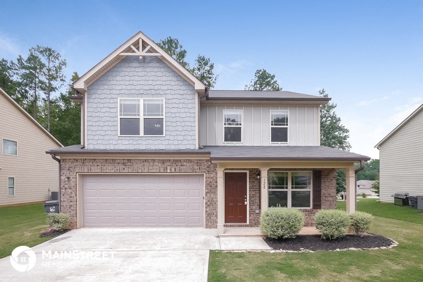 a blue and white house with a garage door