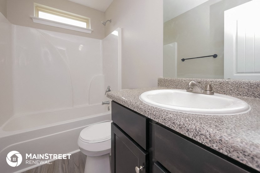 a bathroom with a sink and a toilet and a shower