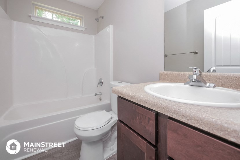a bathroom with a sink and a toilet and a bath tub