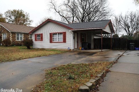A house with red trim and a grey roof.