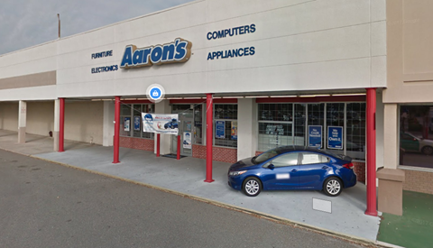 a car is parked in front of a car dealership