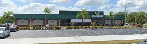 a supermarket with cars parked in a parking lot
