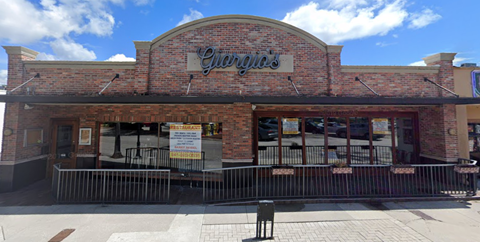 a brick building with a sign on the front of it