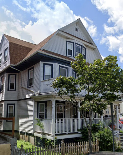 a white house with a porch and a