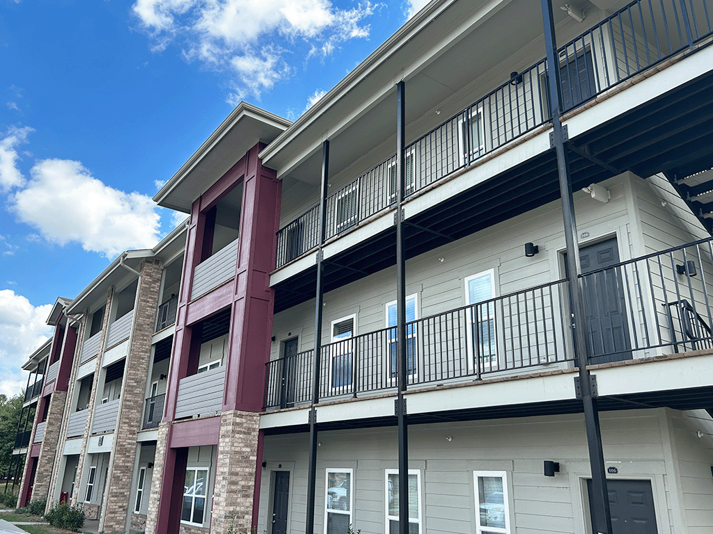 the exterior of an apartment building with balconies