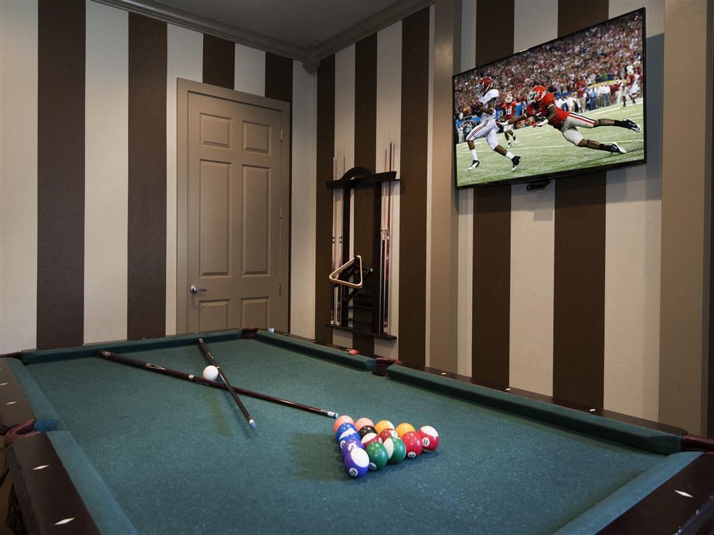 a game room with a pool table and a tv