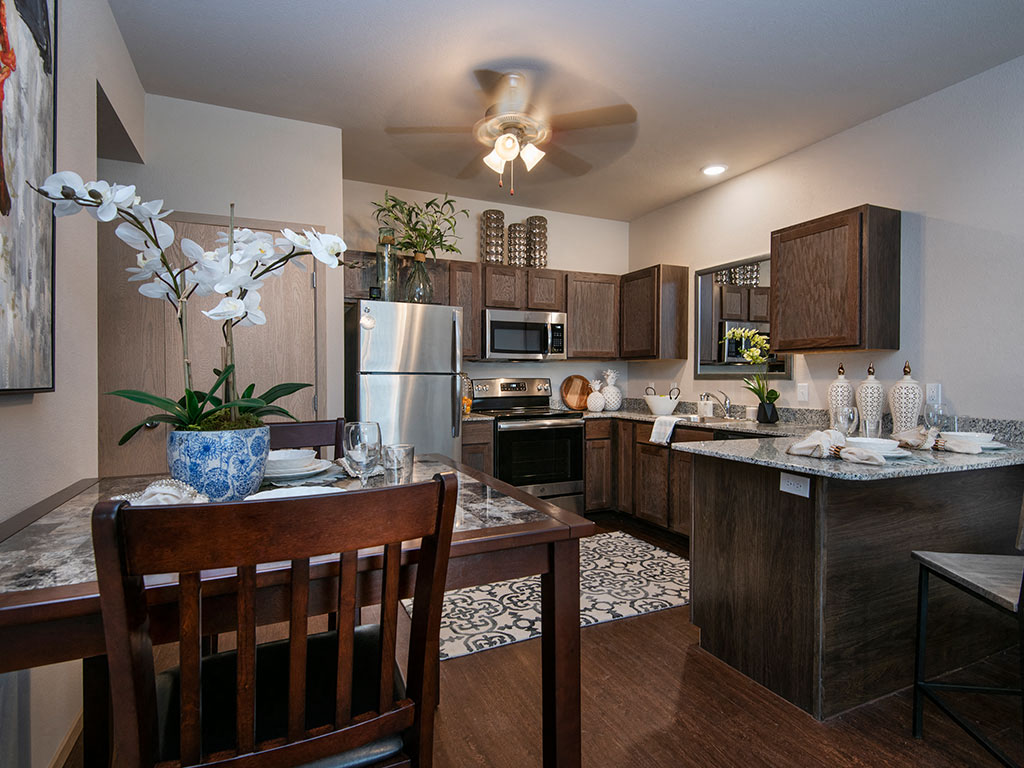 a kitchen and dining room with a table and chairs