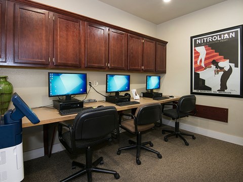 a study room with four computers on a desk