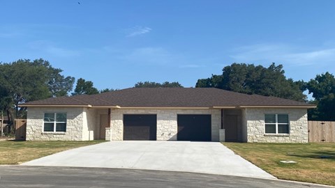 A two-car garage with a stone exterior.
