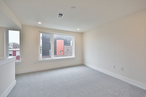 an empty living room with a large window