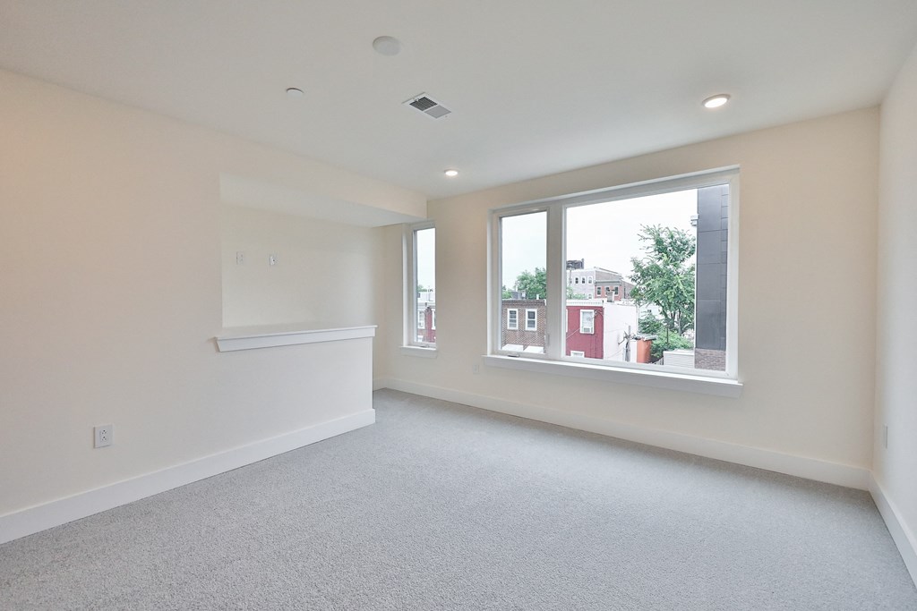 an empty living room with a large window