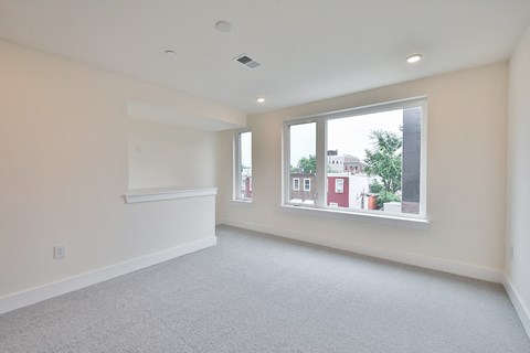 an empty living room with a large window