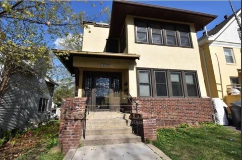 A house with a brick staircase leading to the front door.