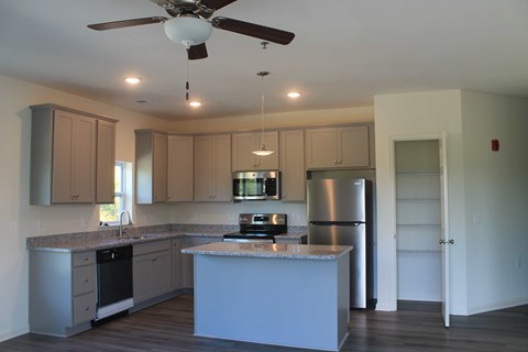 a kitchen with white cabinets and a counter top