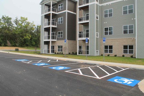 an empty parking lot in front of an apartment building