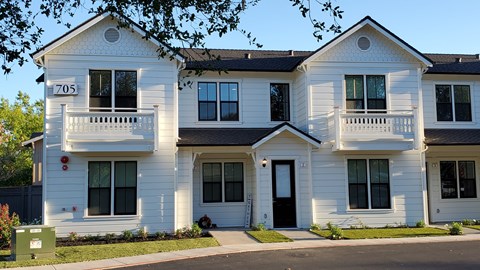 A white two story house with the number 705 on the front.