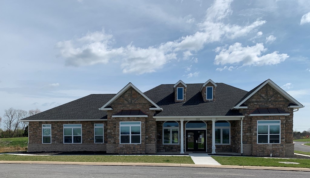 a brick house with a cloudy sky in the background