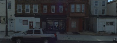 a truck parked in front of a building on a street