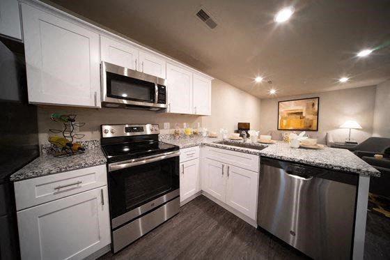 a kitchen with stainless steel appliances and white cabinets
