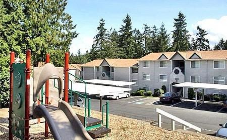 a playground with a slide in front of a building
