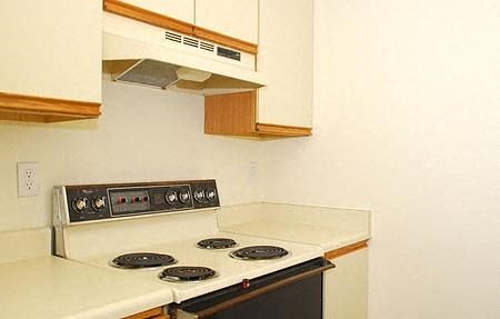 a kitchen with a stove and a microwave