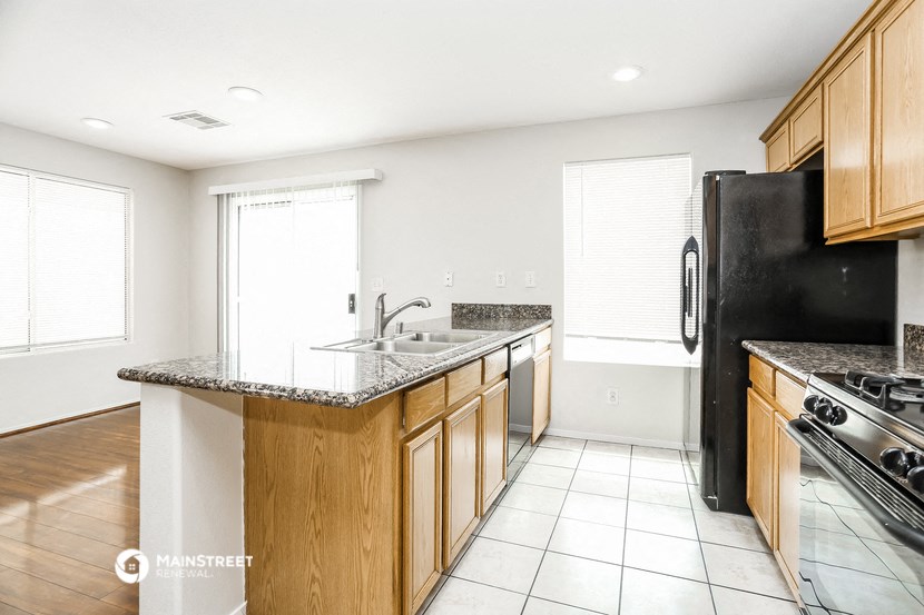 a kitchen with wood cabinets and black appliances and a counter top