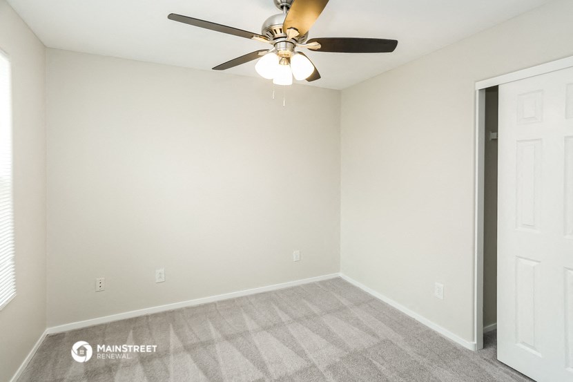 the spacious living room of a manufactured home with a ceiling fan