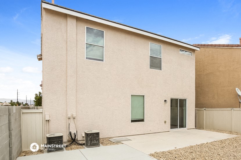 a large brick building with two windows and a sidewalk