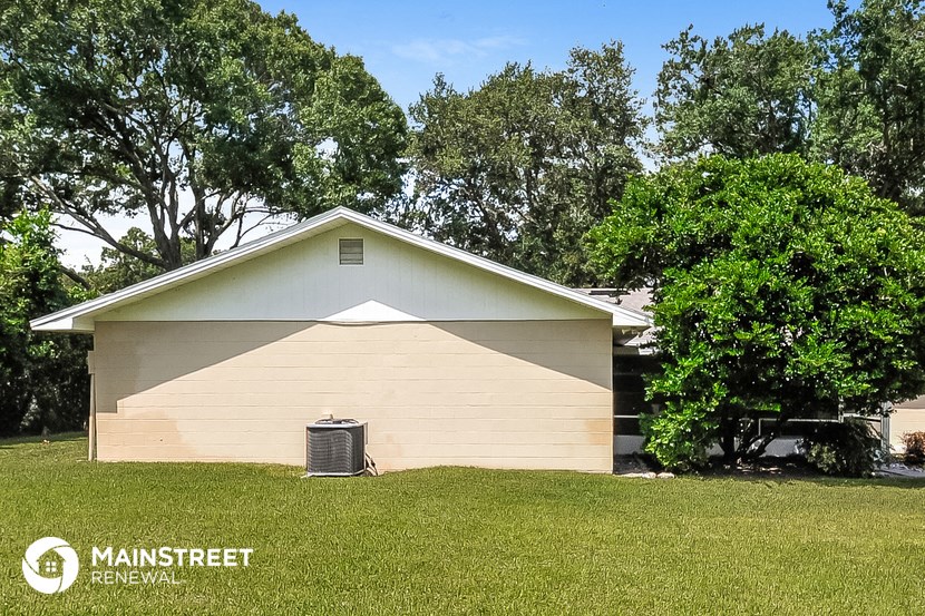 the front of a house with a radiator on the grass