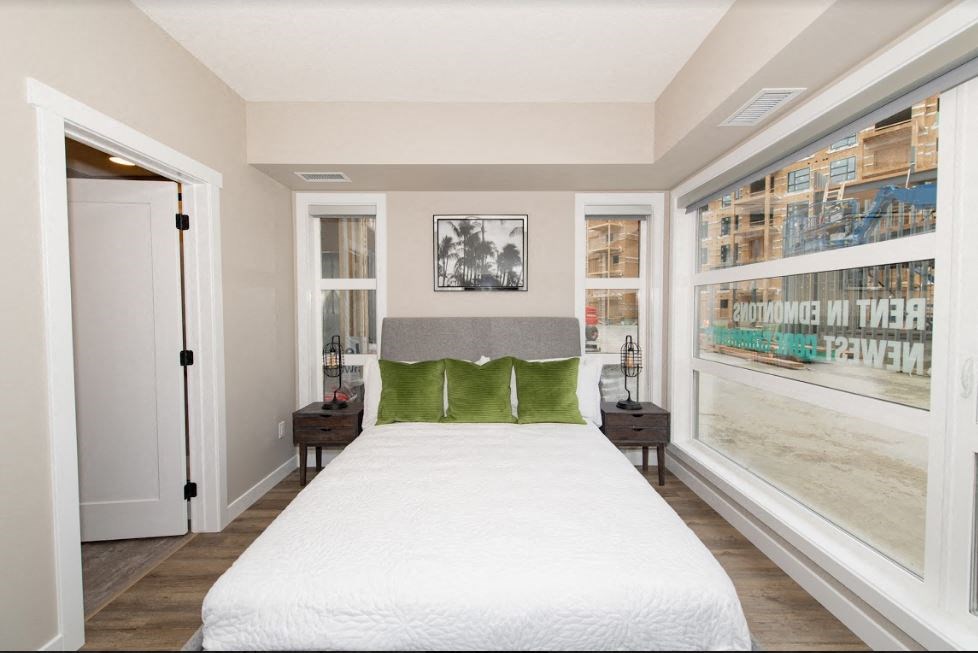 a bedroom with a bed and a window