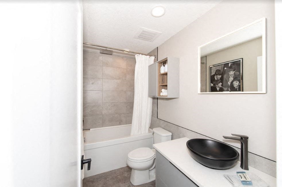 a bathroom with a sink toilet and a shower