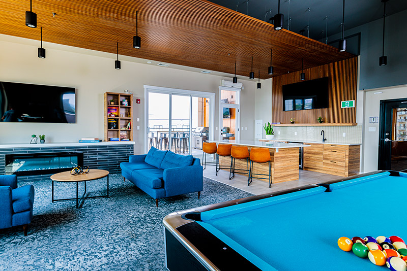 a living room with a pool table and a tv