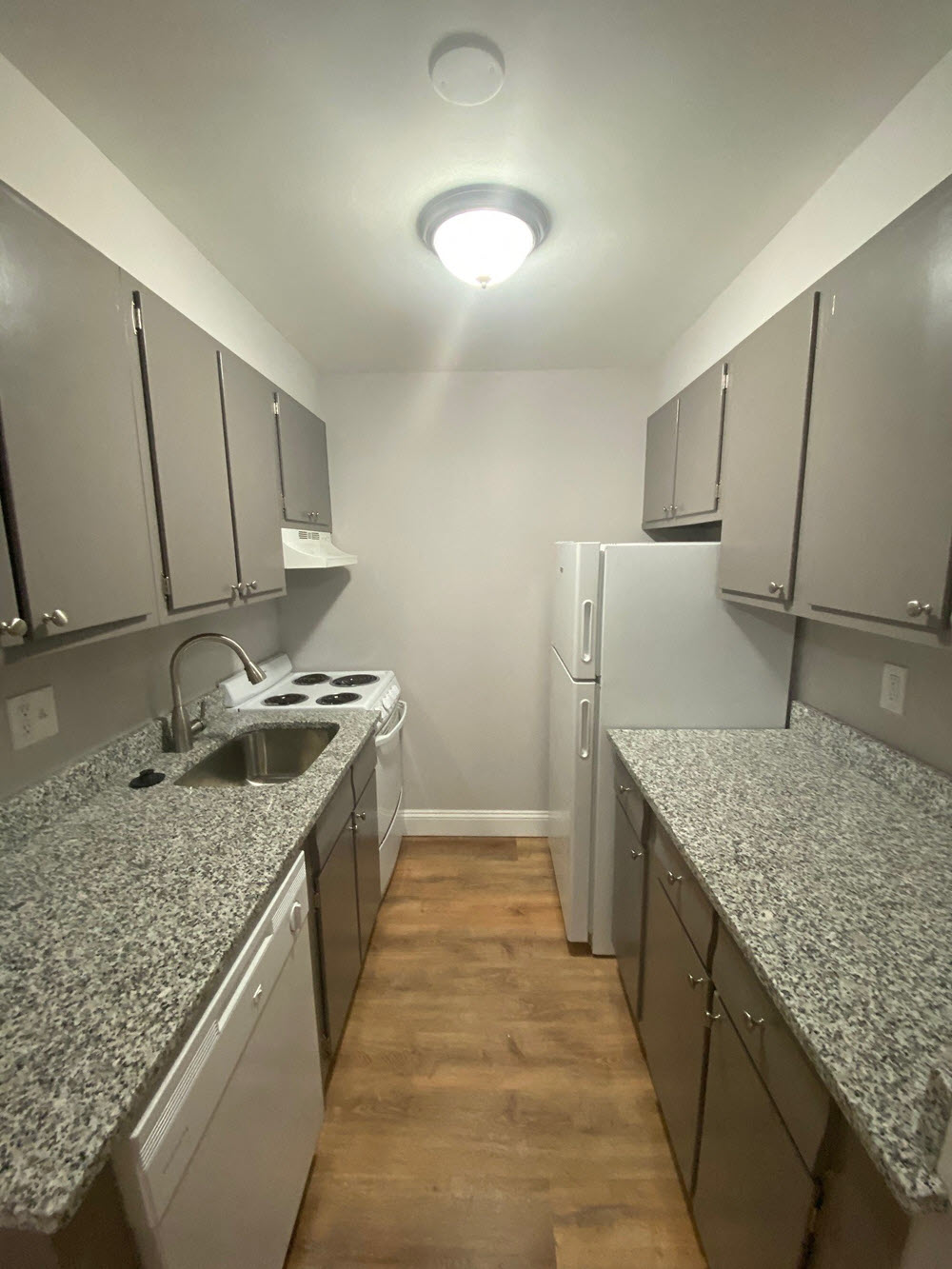a kitchen with granite counter tops and stainless steel appliances