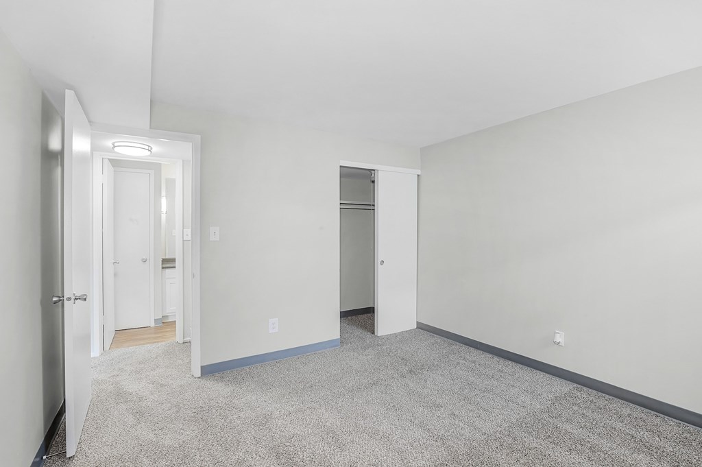 A white room with a door and a window.