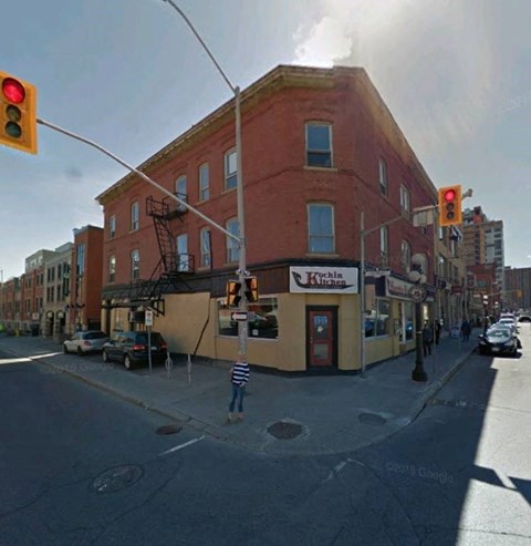A street view of a building with a sign that reads "Kitchen".