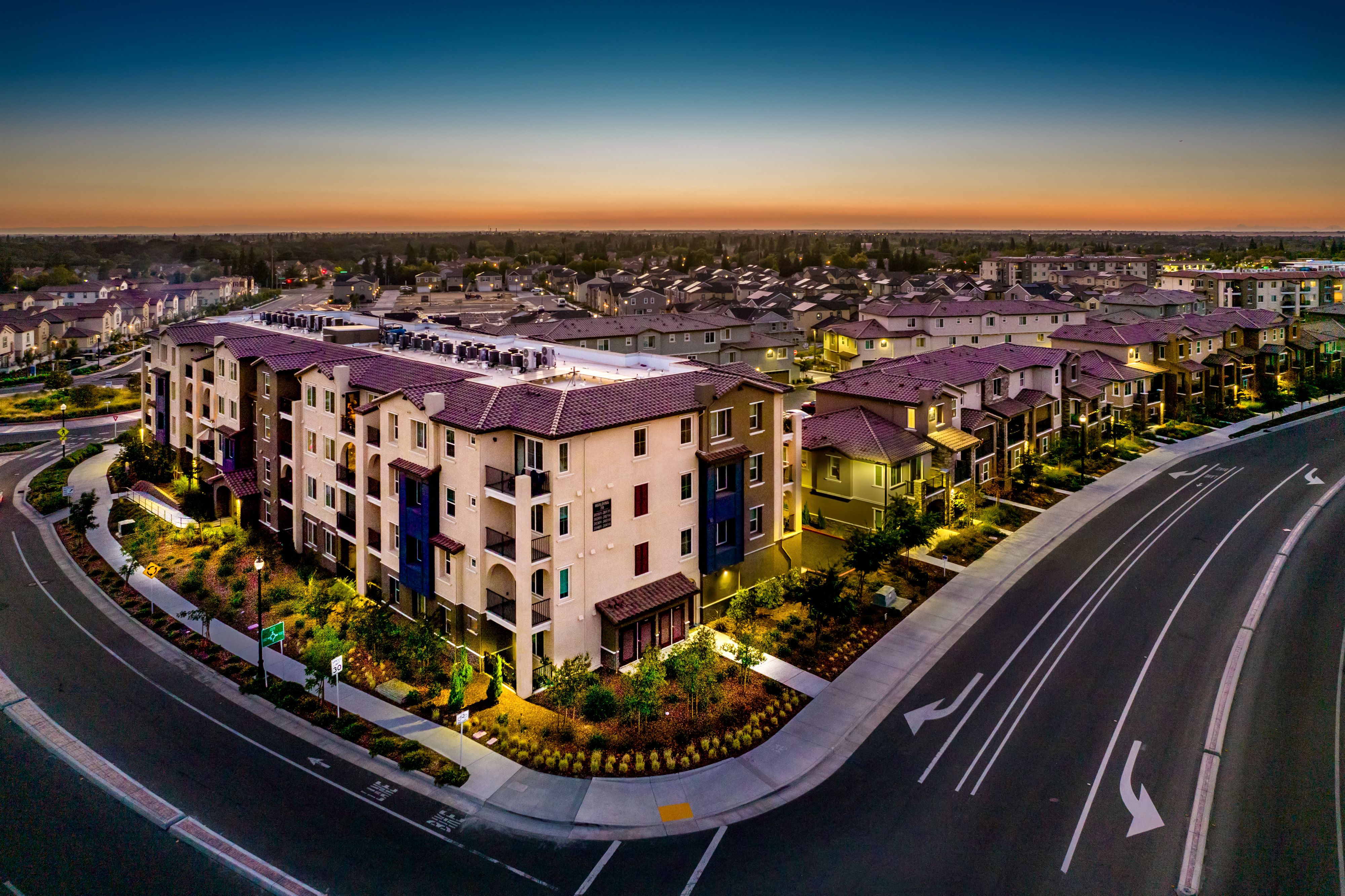 an aerial view of an apartment complex at dusk