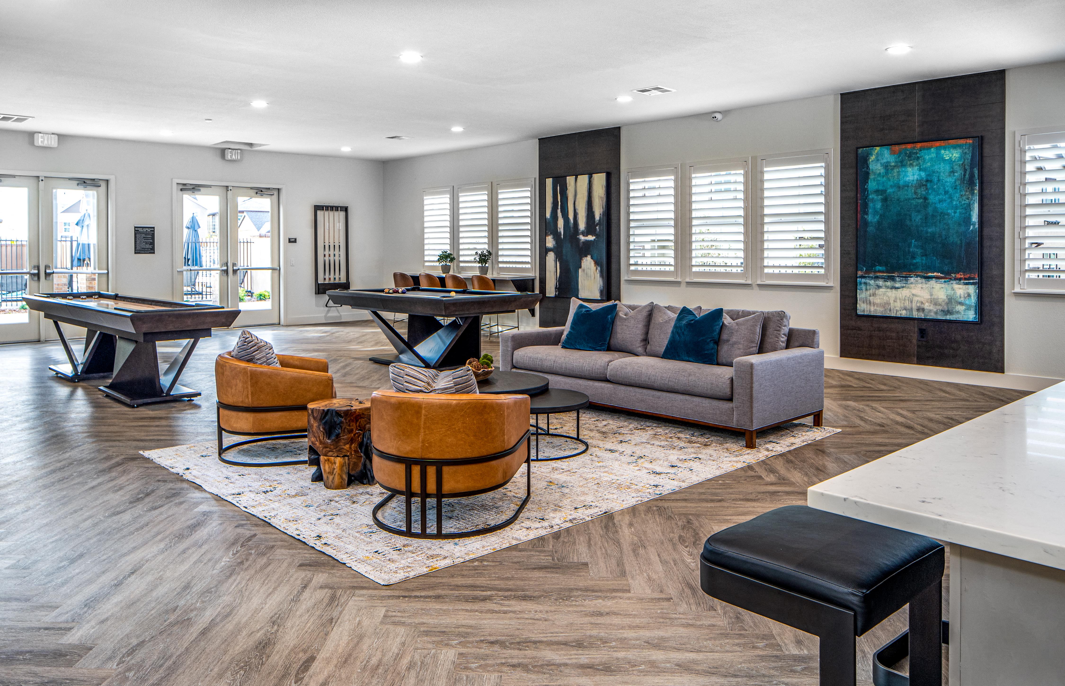 a living room with a billiards table and couches