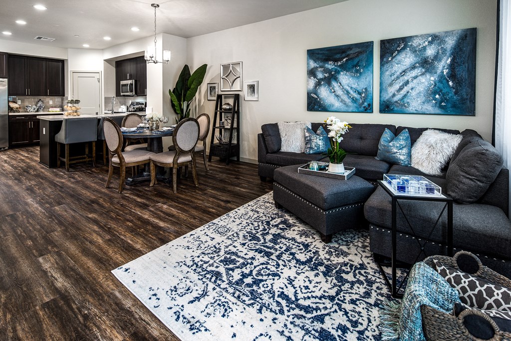 a living room with a couch and a table and a kitchen
