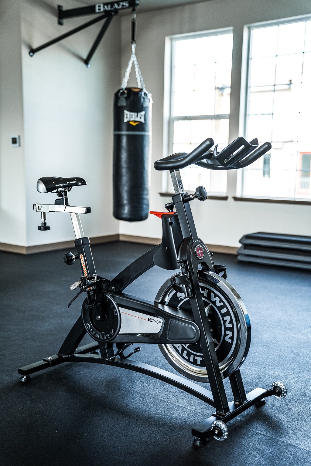 a bike in a gym next to a punching bag