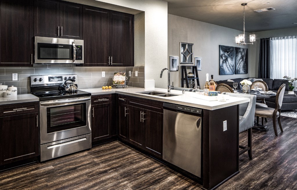 a kitchen and dining room with stainless steel appliances and a counter top