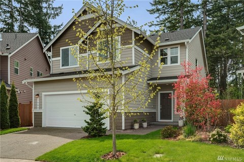 A house with a tree in front of it.