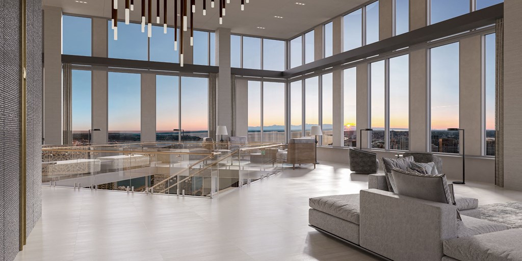 a living room with floor to ceiling windows and a view of the city