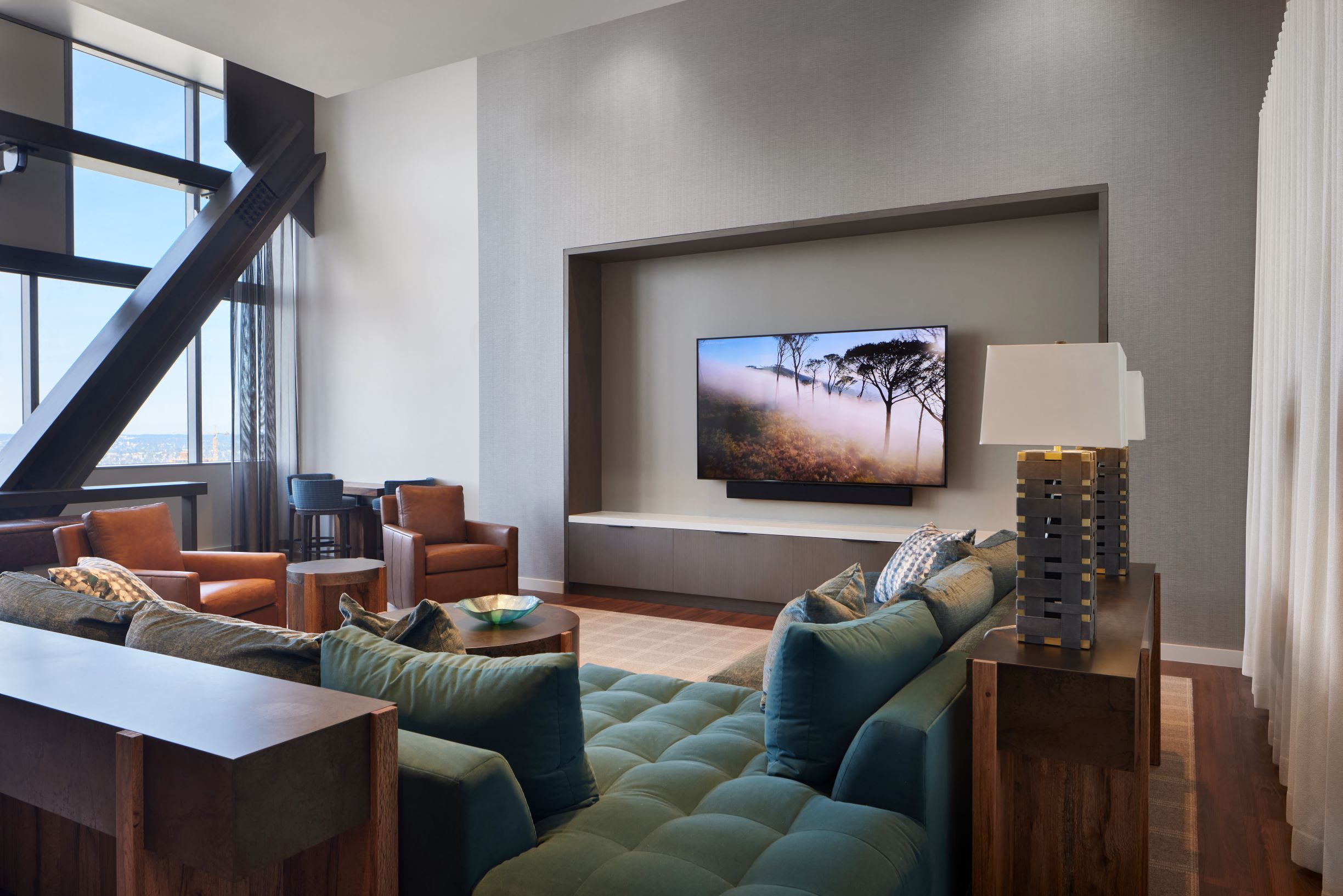 media lounge with plush seating, big screen TV and bar area