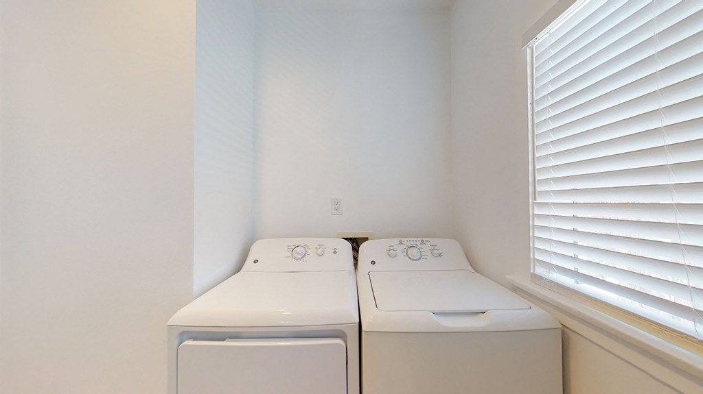 the washer and dryer in the laundry room of a home