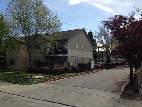 an empty street in front of an apartment building