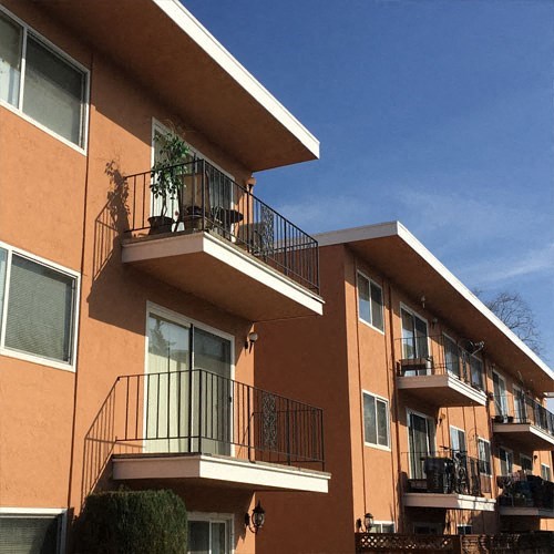 an apartment building with balconies on top of it