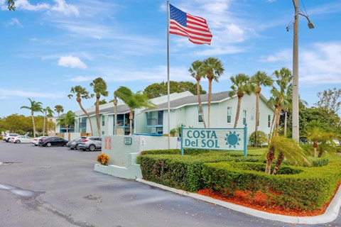 The image shows a building with the sign "Costa Del Sol" in front of it.
