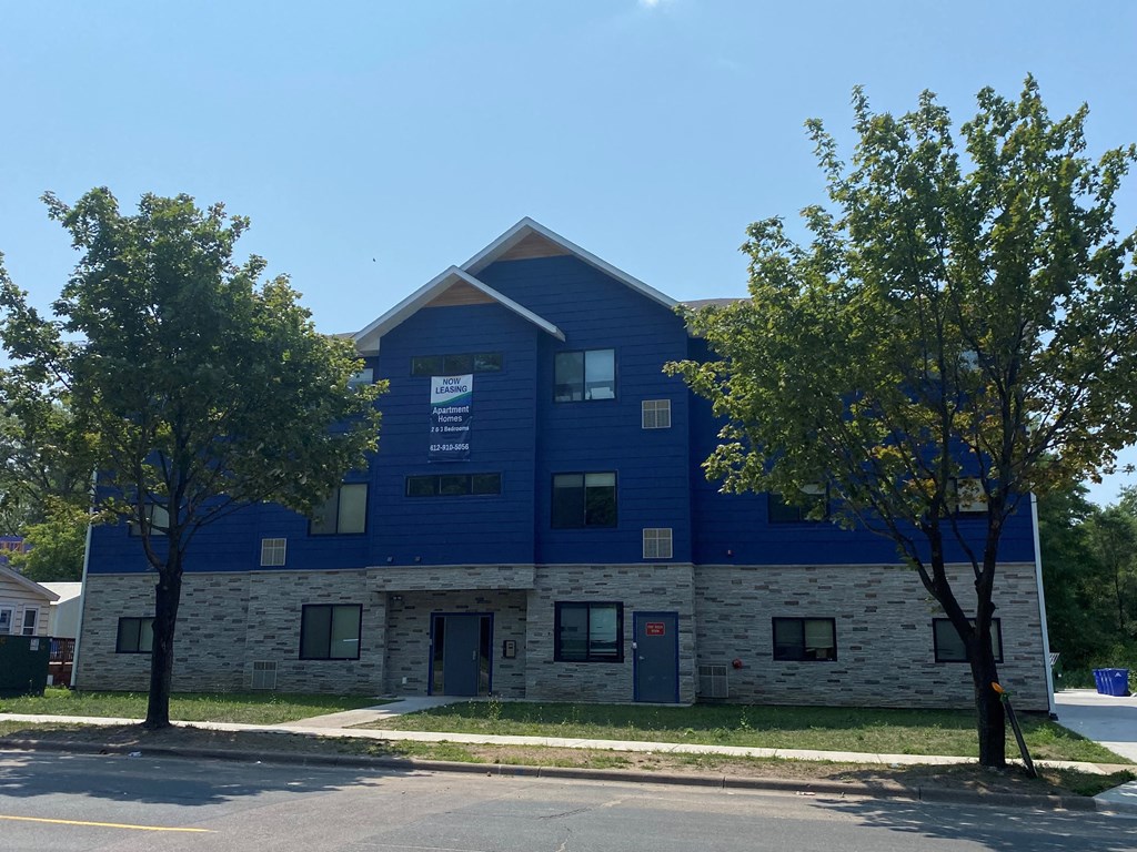 a blue and white building with trees in front of it