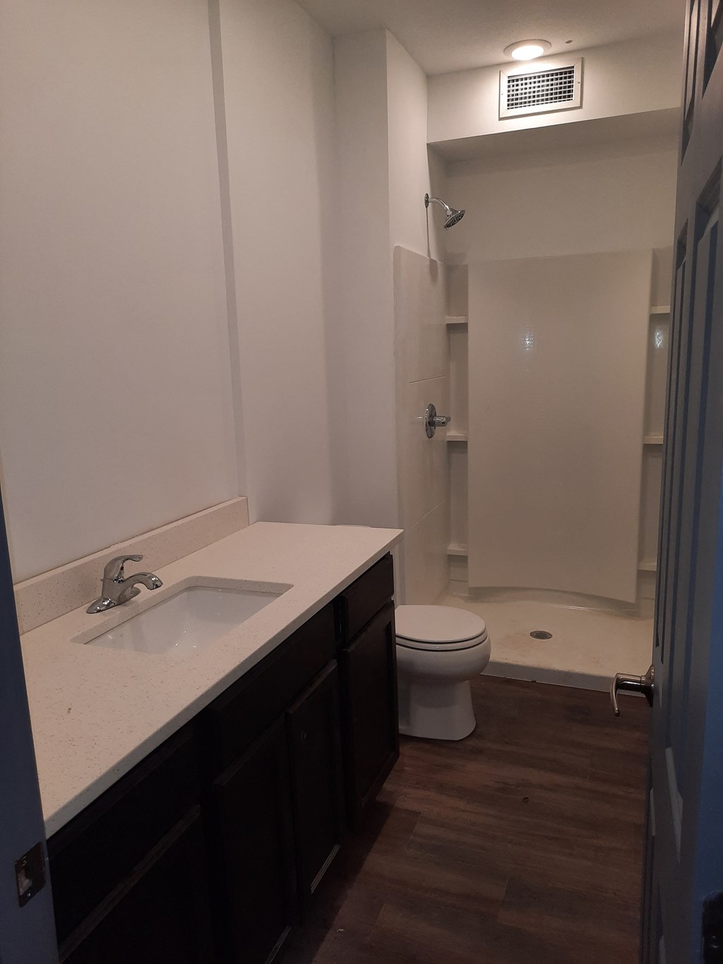 a bathroom with a sink and a toilet and a shower