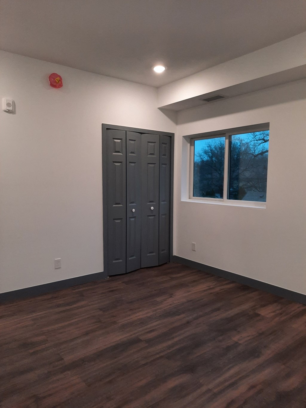 an empty room with a window and a door